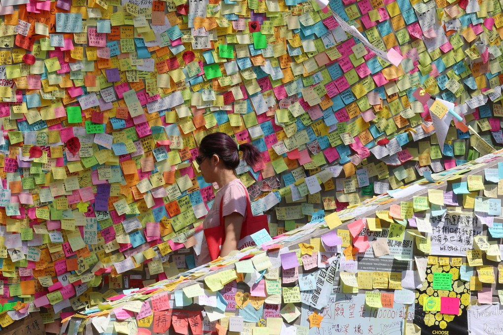 Hundreds of notes supporting the pro-democracy protest movement are posted on a wall outside the government offices in Admiralty. Events of the past week are the culmination of new and old local political conflicts. Photo: David Wong