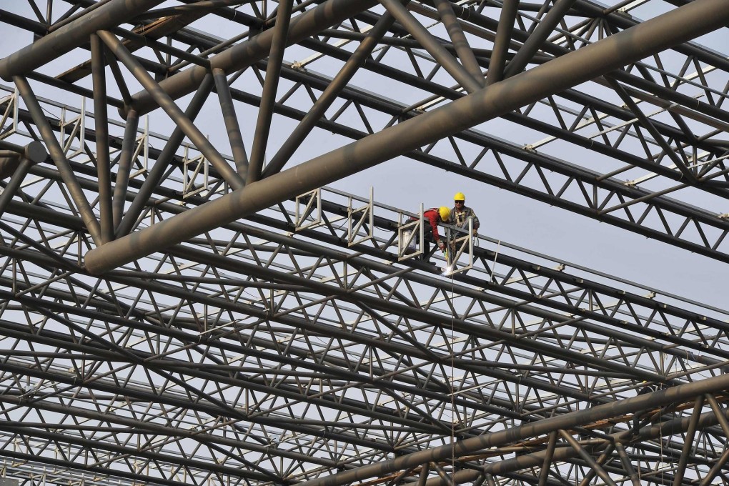 Labourers build a railway station in Hefei, Anhui. Beijing wants to see logistics costs lowered to 16 per cent of GDP by 2020. Photo: Reuters