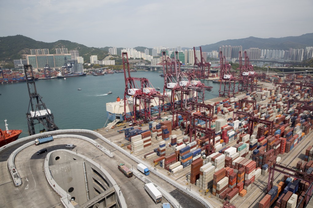 A shipping vessel sits docked near container cranes at the Kwai Tsing Container Terminals in Hong Kong. Photo: Bloomberg