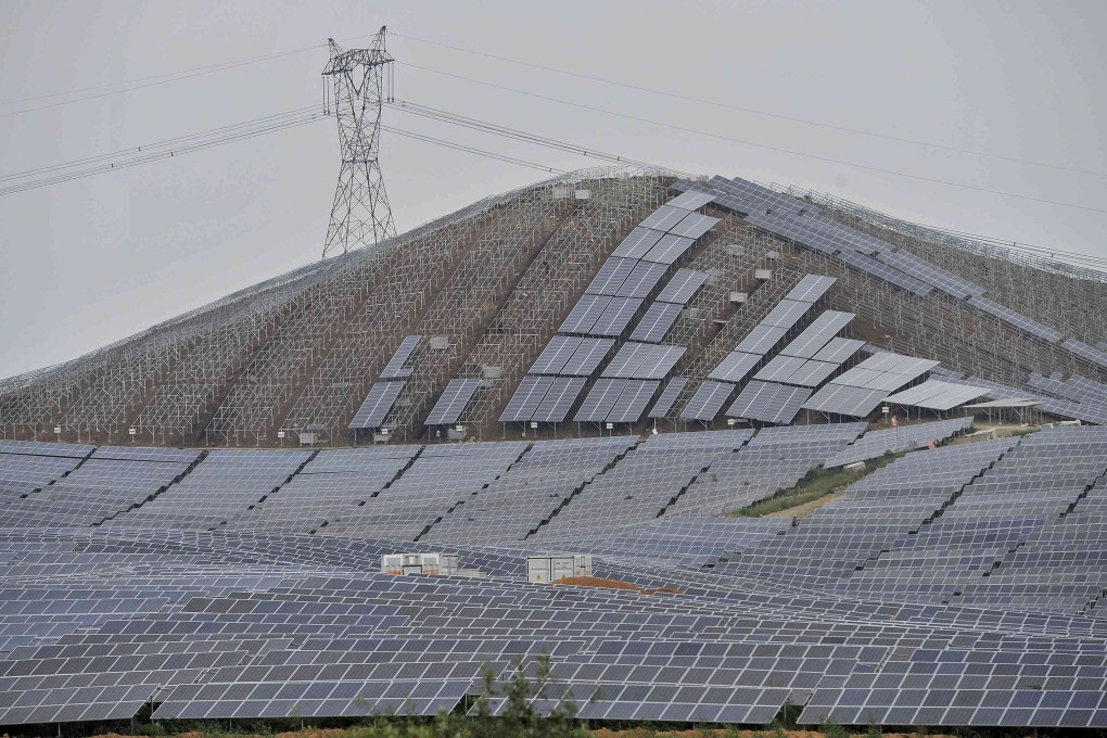 An electricity pylon above a solar power plant is under construction on a hill in Wuhu, China. Photo: Reuters