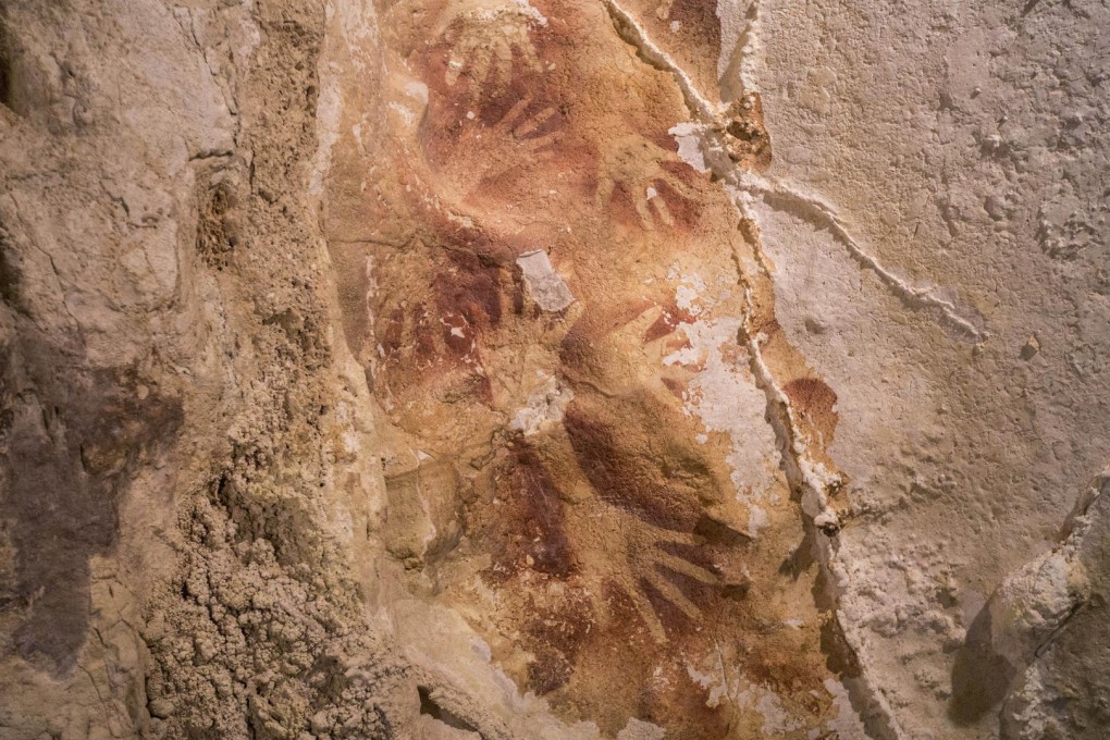 Hand stencils on a cave wall in Sulawesi date back 40,000 years. Photo: AFP