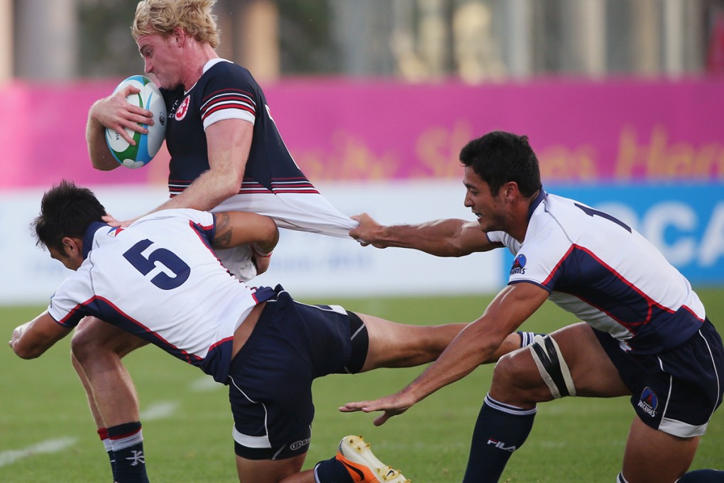 Hong Kong skipper Jamie Hood tries to escape the Philippines defence during the Asian Games in Incheon last week. Hood and his team-mates will have home field advantage for the Asian qualifying tournament ahead of the 2016 Rio Olympics. Photo: Nora Tam/SCMP