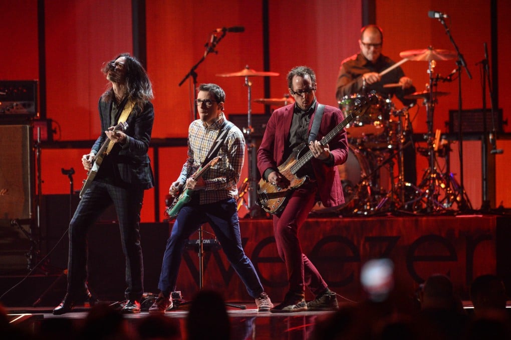 Weezer performing at the iHeartRadio Music Festival in Las Vegas in late September. The band's new album is Everything Will Be Alright in the End (bottom left). Photos: AP