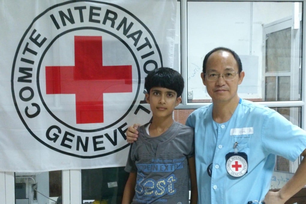 Dr Au Yiu-kai at the hospital in Khan Younis, Gaza, with a 15-year-old boy who was able to walk again after Dr Au removed shrapnel from his thigh. Photo: SCMP Pictures