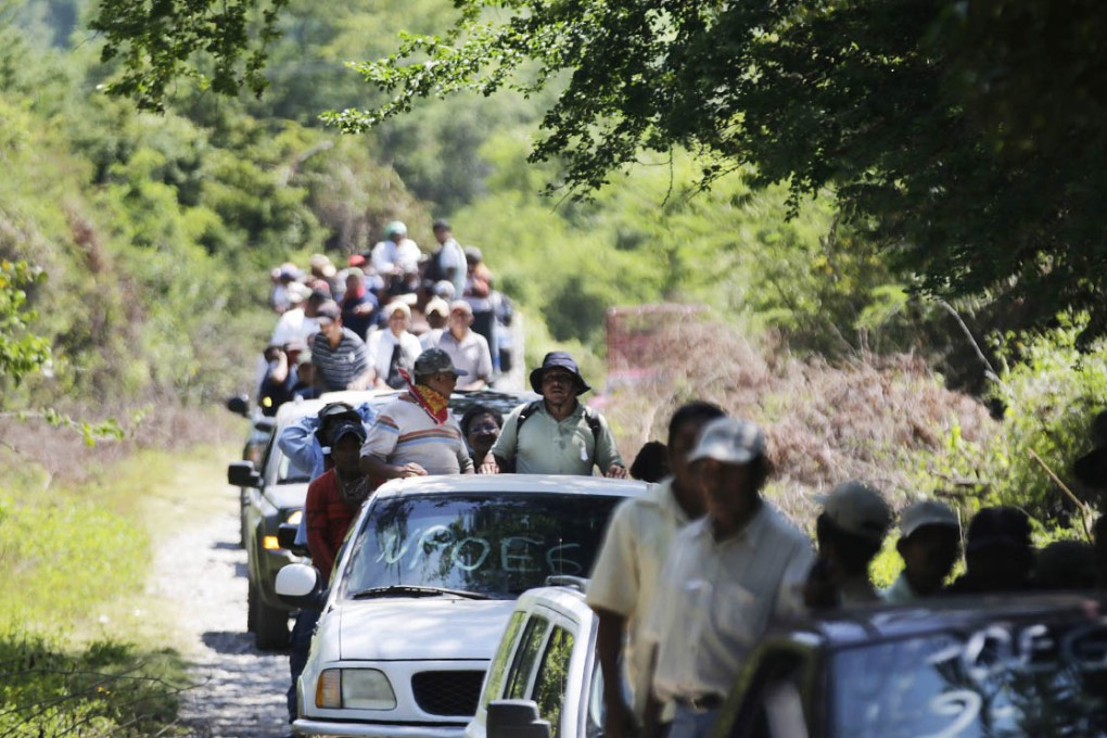 Members of the Public Safety System, the community police of Guerrero state, are seen in vehicles as they help in the search for the missing 43 students in the town of Las Juntas outside Iguala, southern Mexican. Photo: Reuters