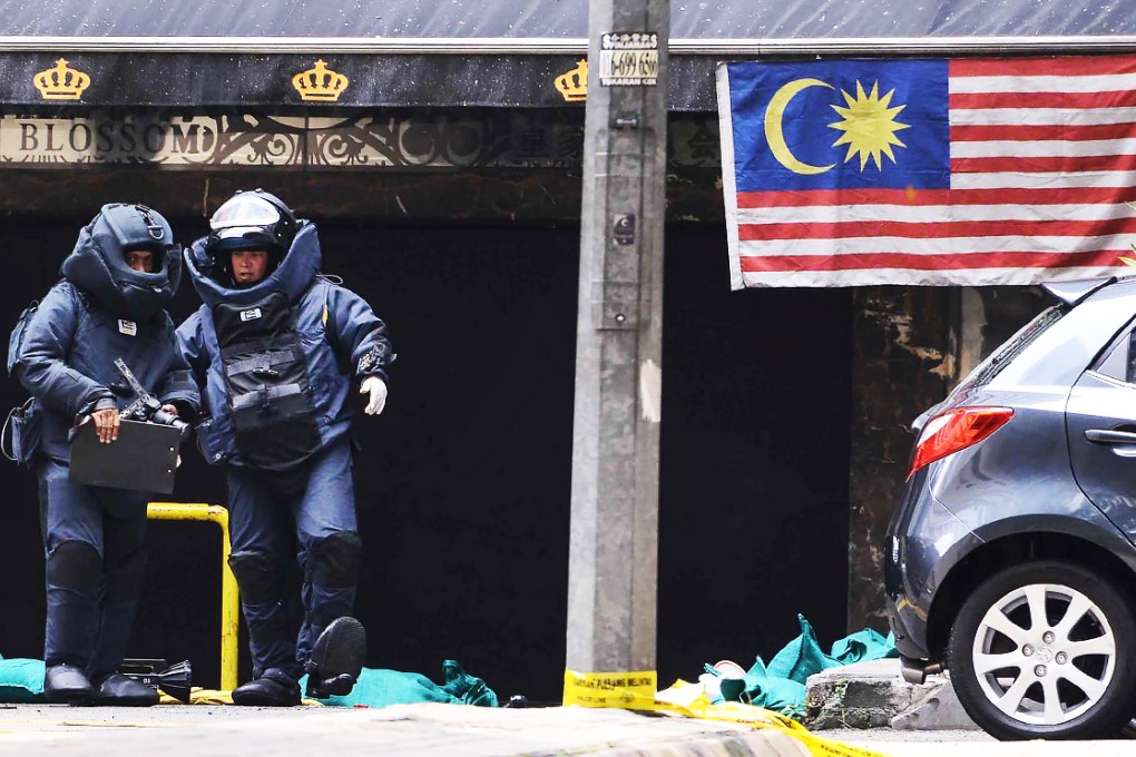 Bomb squad officers at the scene of the grenade attack outside the Sun Complex in the Bukit Bintang district of Kuala Lumpur. Photo: AFP
