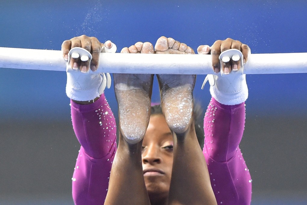 Simone Biles performs on the uneven bars, one of the four apparatuses in the women's all-around final in Nanning. Photo: AFP