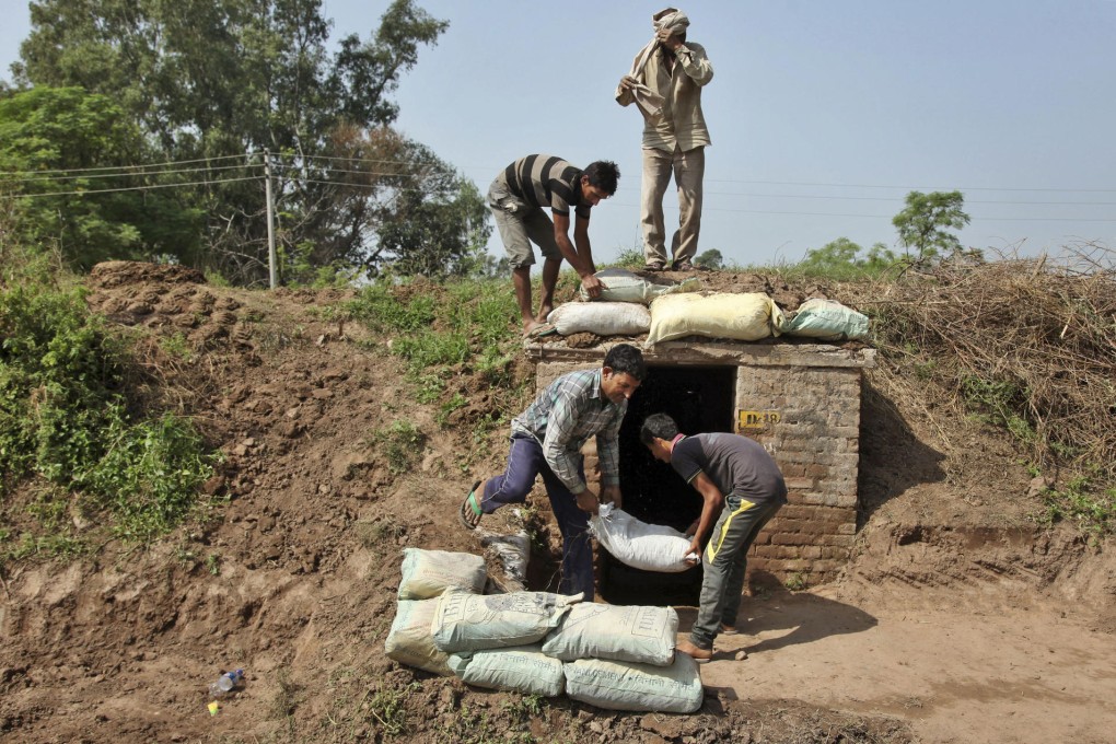 Indian villagers prepare a bunker amid fighting in Kashmir.