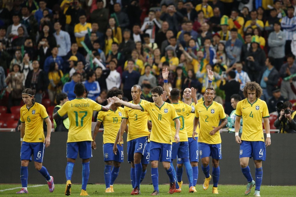 Brazil's Diego Tardelli (third from right) celebrates with his teammates after completing his brace against Argentina. Photo: Reuters