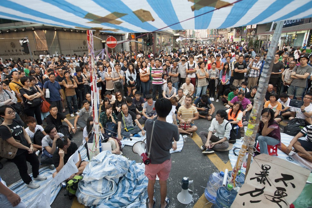 A young man makes a political speech in the Occupy Mong Kok pro-democracy protest camp. Photo: EPA