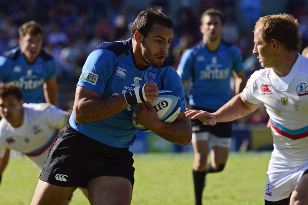 Centre Joaquin Prada runs in a try for Uruguay against Russia during their RWC repêchage match in Montevideo on Saturday. Uruguay won 36-27 to complete the line-up for London 2015. Photo: AFP
