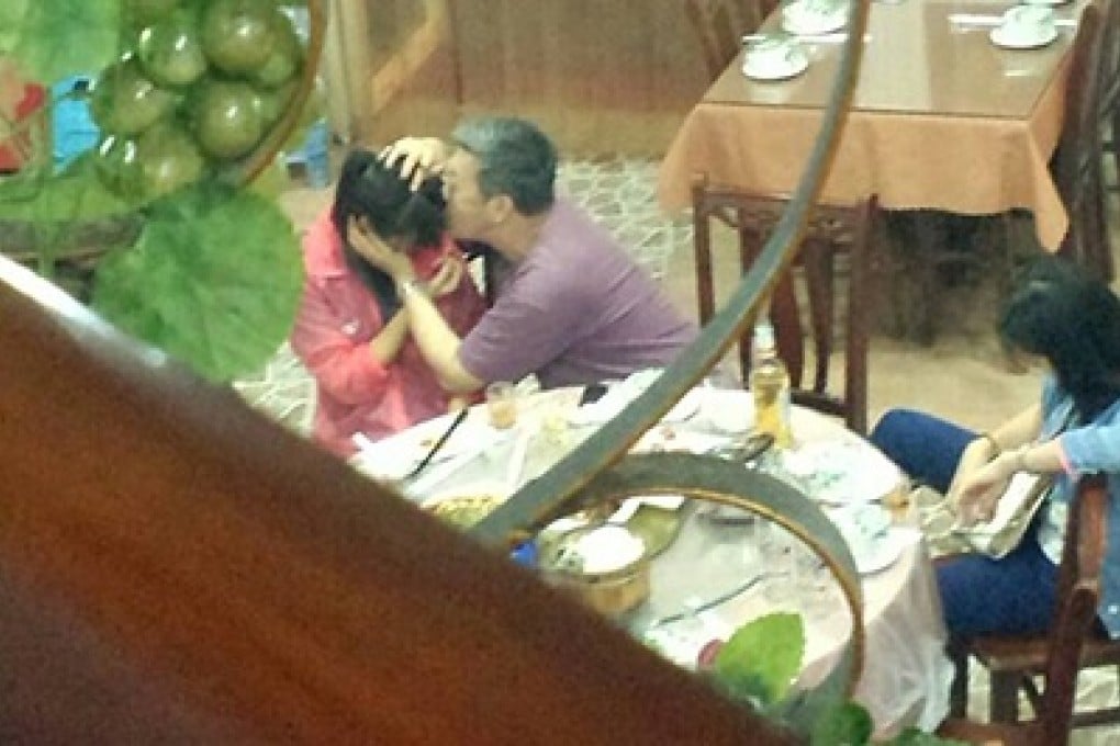 Retired associate professor Wang Xiaojian was caught hugging and kissing two female students at a restaurant.