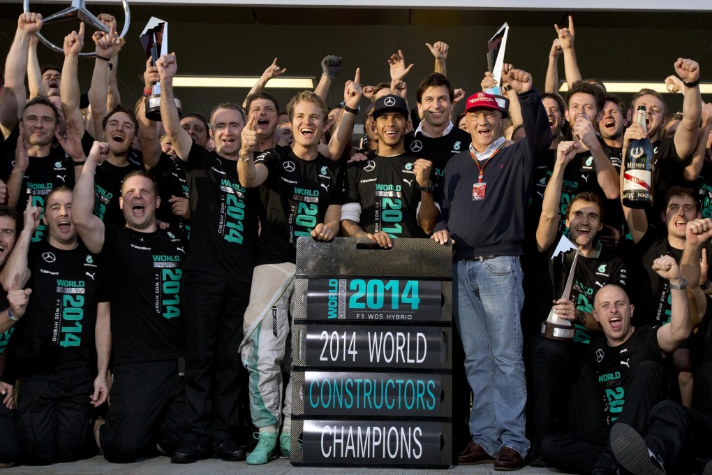 Lewis Hamilton celebrates landing the constructors' title for Mercedes with teammate Nico Rosberg and the team's non-executive chairman and former driver Niki Lauda. Photos: AP