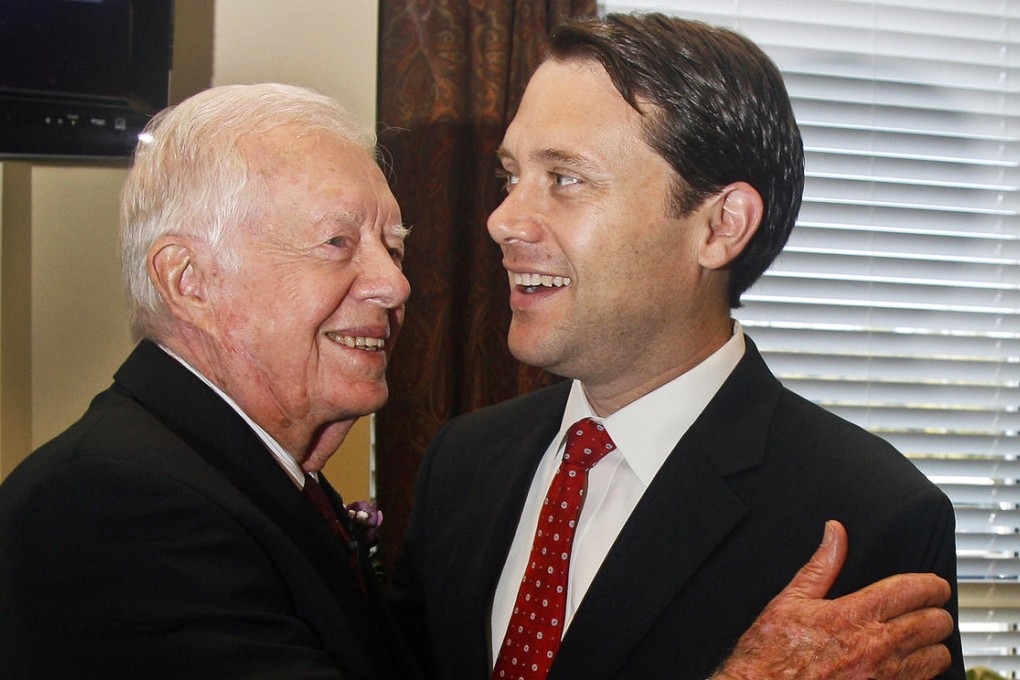 Former president Jimmy Carter hugs grandson Jason. Photo: AP