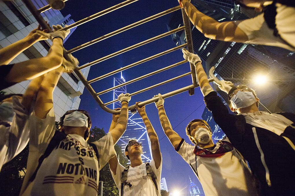 Pro-democracy protesters rebuild barricades on Queensway. Photo: EPA