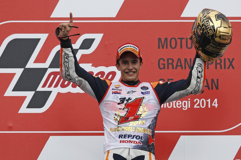 Spain's Marc Marquez celebrates on the podium after sealing the world championship following a second place finish in the Motorcycling Grand Prix of Japan. Photos: EPA