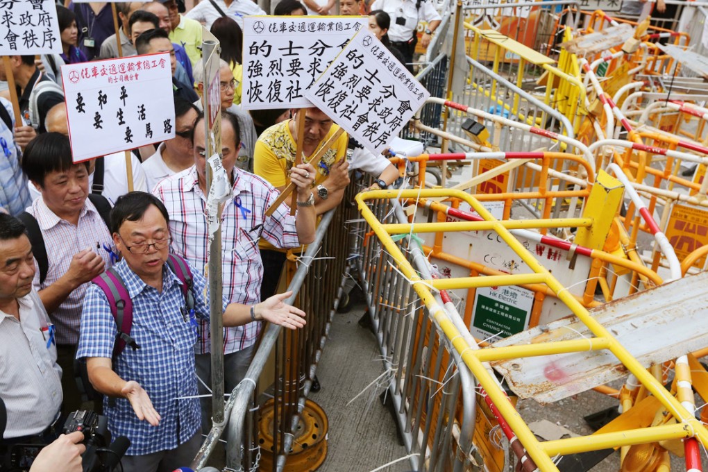Taxi drivers demand that barriers at Admiralty be removed. Some barriers in Mong Kok were removed yesterday. Photo: Sam Tsang