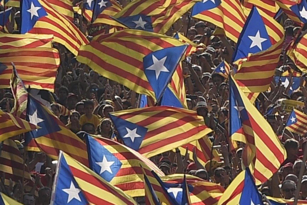 Catalans hold independence flags during celebrations of Catalonia National Day in central Barcelona on September 11. Photo: AFP