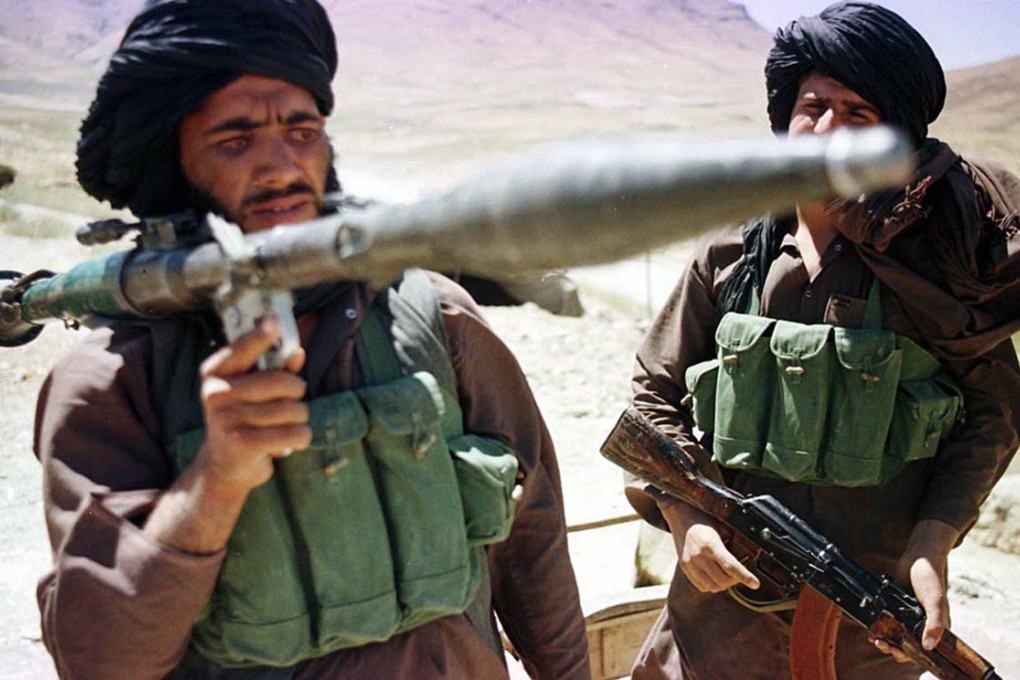 Taliban fighters show off their weaponry in a battle.