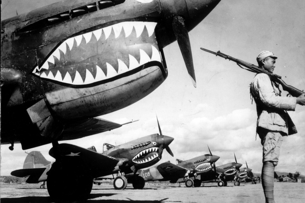 In this 1943 photo, guarded by a Chinese soldier, a squadron of Curtiss P-40 fighter planes, decorated with the typical shark face of the famed Flying Tigers, are lined up at an unknown airbase in China. An airfield in southern China from which the famed Flying Tigers took off to fight Japanese warplanes is being converted to battle a new enemy: drought. Photo: AP