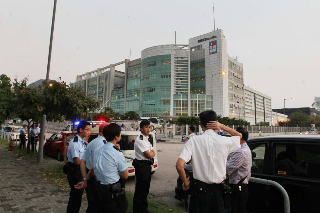 Police officers outside the Apple Daily offices in Tseung Kwan O. Photo: Handout