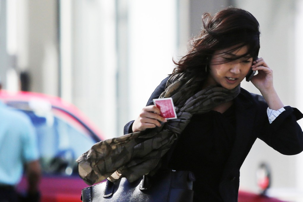 Strong winds from Typhoon Vongfong buffet Tokyo commuters on Tuesday. Photo: Reuters
