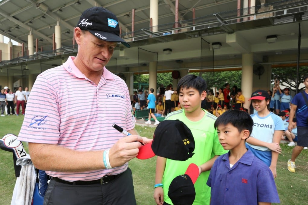 Ernie Els signs autographs for Hong Kong children during a golf clinic in Tuen Mun. Photos: SCMP Pictures