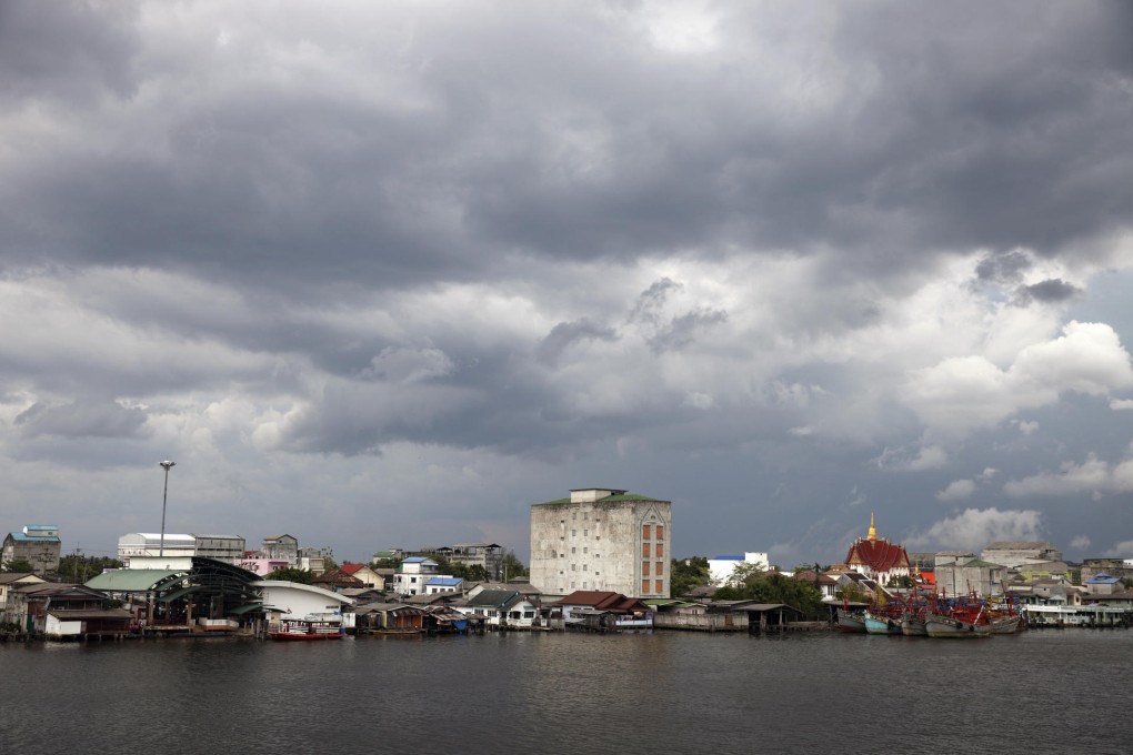 A "bird's-nest condo" block dominates the skyline of Pak Phanang, in Thailand. Photos: Luke Duggleby; AFP
