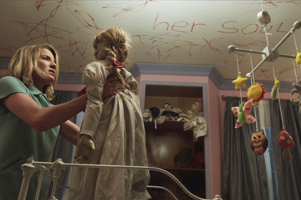 Annabelle Wallis, left as Mia, with the Annabelle doll in New Line Cinema's supernatural thriller Annabelle. Photo: AP/Warner Bros. Pictures