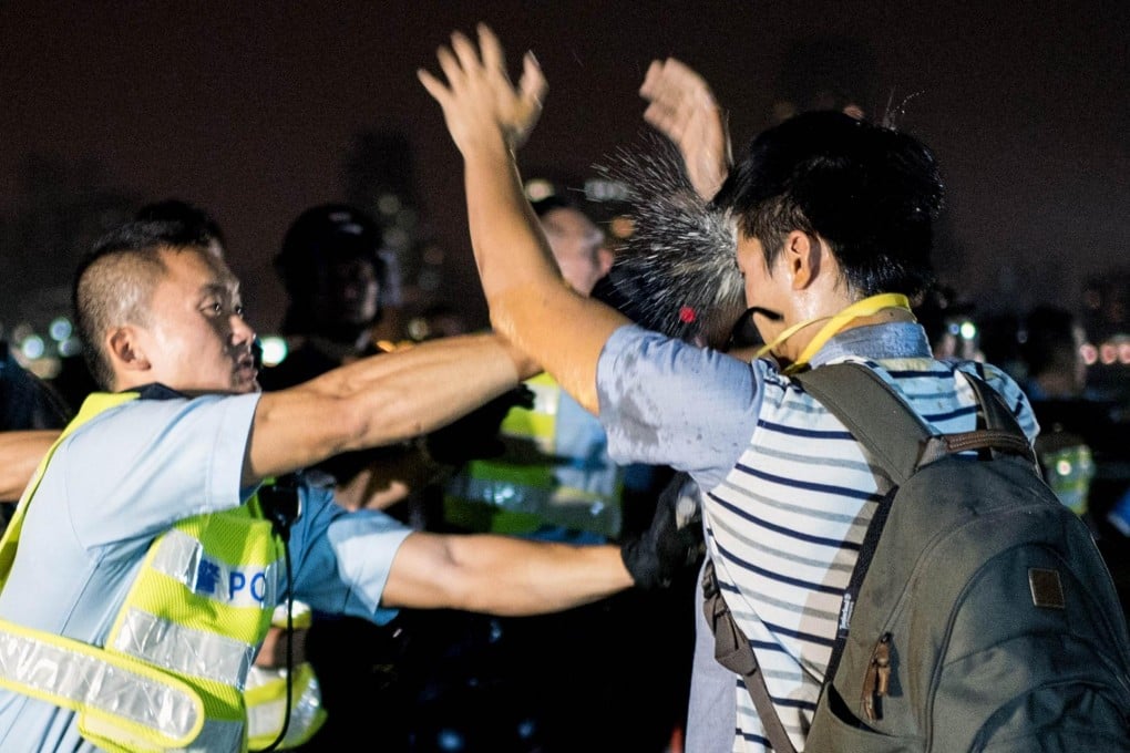 An officer uses pepper spray. Photo: AFP