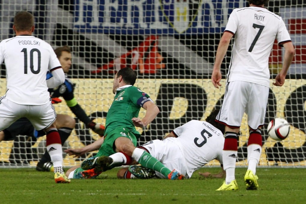 John O'Shea scores the equaliser against Germany. Photo: EPA