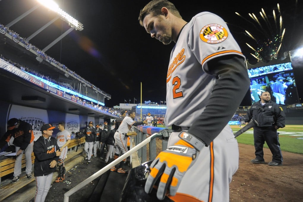 The Baltimore Orioles' J.J. Hardy returns to the clubhouse as fireworks shoot above the ballpark while the Kansas City Royals celebrate a 2-1 win in game three of the American League Championship Series. Photo: MCT