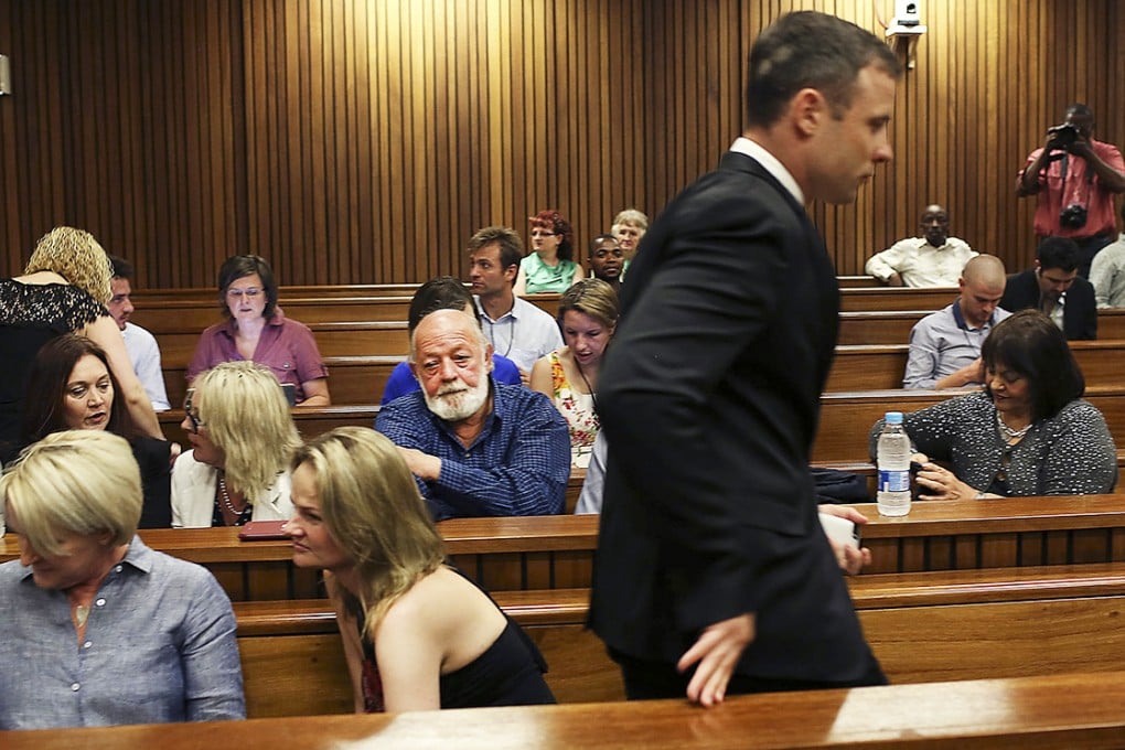 Oscar Pistorius passes by members of the Steenkamp family as he arrives for the fourth day of sentencing proceedings in the High Court in Pretoria. Photo: AP