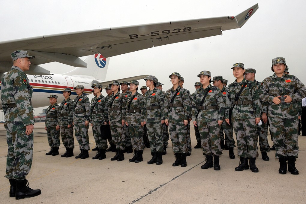 Members of a Chinese laboratory team line up in Beijing in mid September before departing for Sierra Leone to help contain the Ebola epidemic. Photo: Xinhua