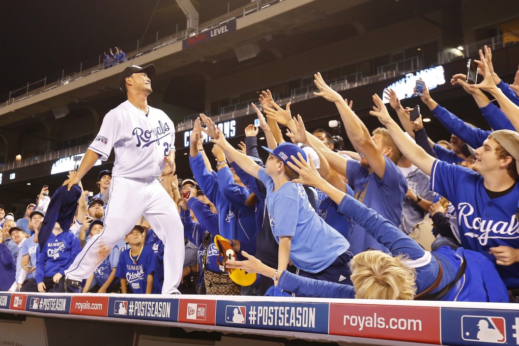 The Royals' Nori Aoki celebrates with fans after the series sweep. Photo: EPA