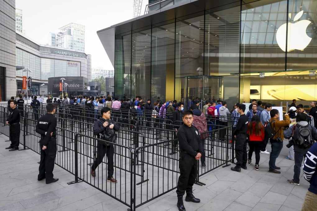 Customers queue outside an Apple store in Beijing. Photo: EPA