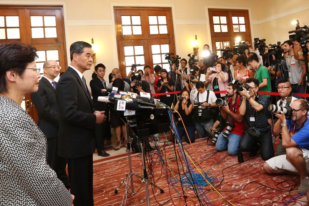 Chief Secretary Carrie Lam, Secretary for Constitutional and Mainland Affairs Raymond Tam, and Chief Executive Leung Chun-ying speak to the press at Government House. Photo: Felix Wong