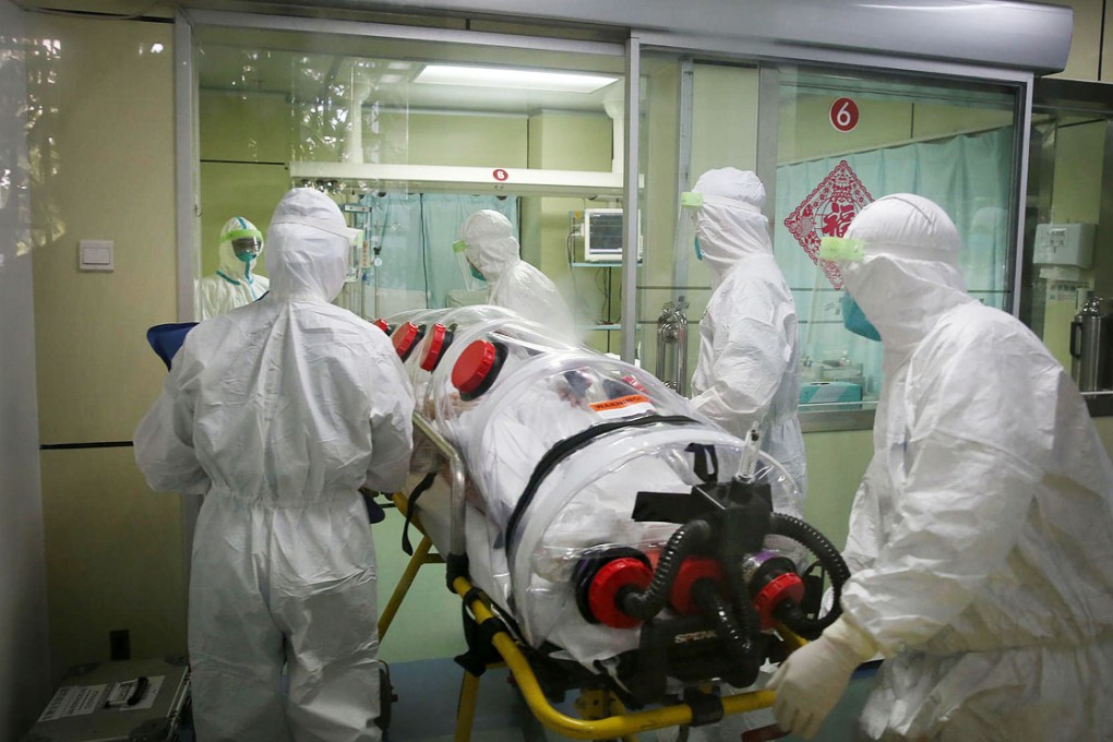 Health workers in a Guangzhou hospital take part in an Ebola drill with a mock patient. Photo: China Foto Press