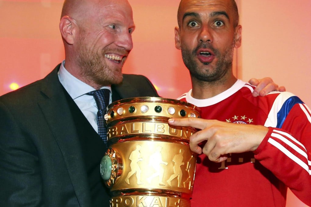 Pep Guardiola celebrates winning the German DFB Cup with Bayern's sports director Matthias Sammer in May, completing a domestic double. Guardiola is satisfied the squad are buying in to his system of play and he plans to continue his revolution with the Bavarian giants, as documented in Marti Peraranu's new book Pep Confidential, excerpted on this page. Photos: AFP, Reuters, EPA, AP