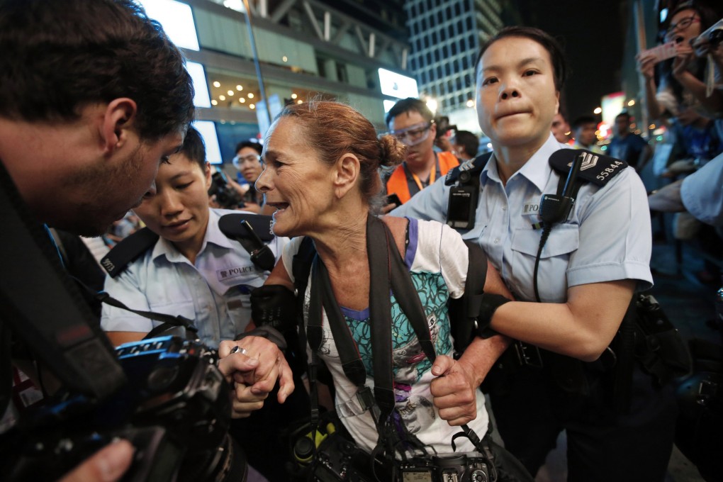 Paula Bronstein was arrested on suspicion of criminal damage after jumping onto a car to take photos. Photo: Reuters