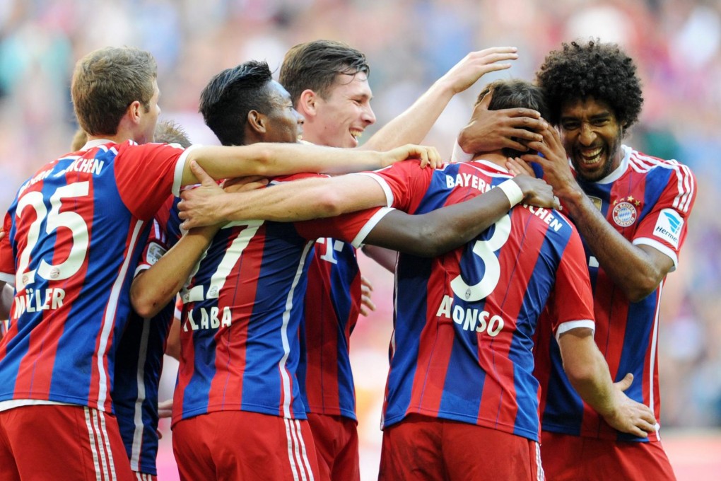 Bayern Munich players congratulate Xabi Alonso after his goal made it 2-0 against Werder Bremen. Photo: EPA