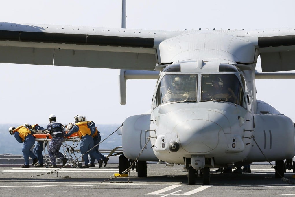 An "injured" participant is wheeled from an MV-22 Osprey aircraft during the disaster drill. Photo: Kyodo