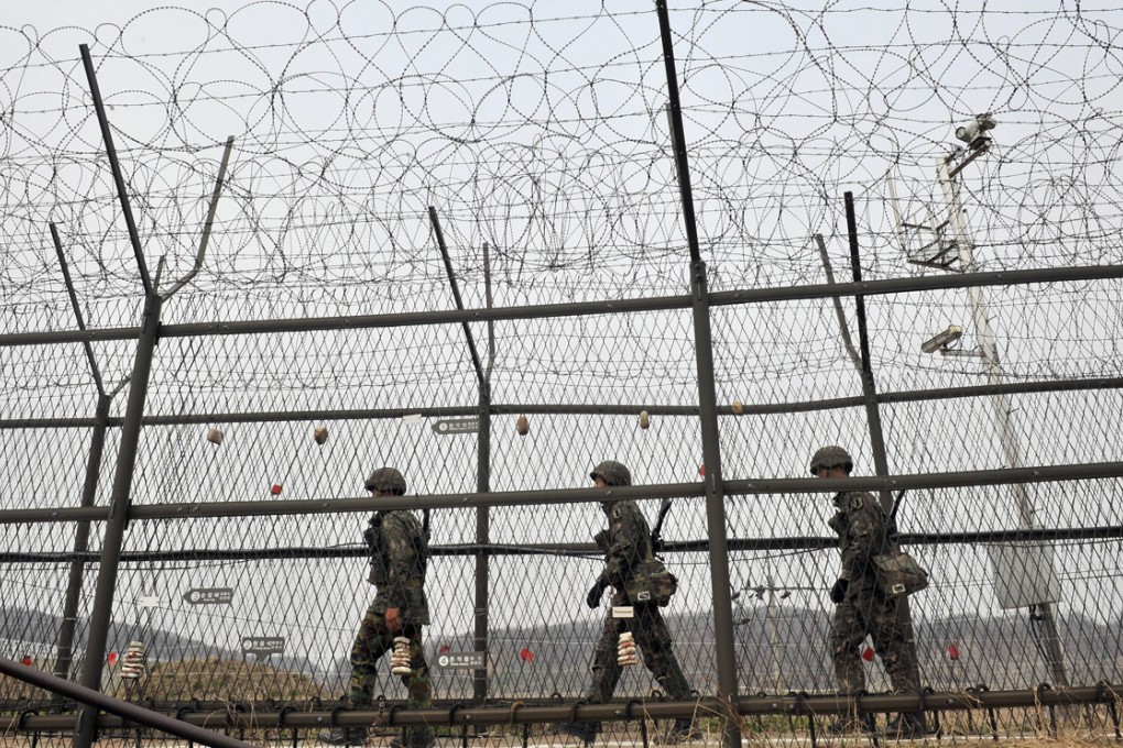 South Korean soldiers patrol along a military fence near the Demilitarised Zone (DMZ) dividing the two Koreas in this file picture. Photo: AFP