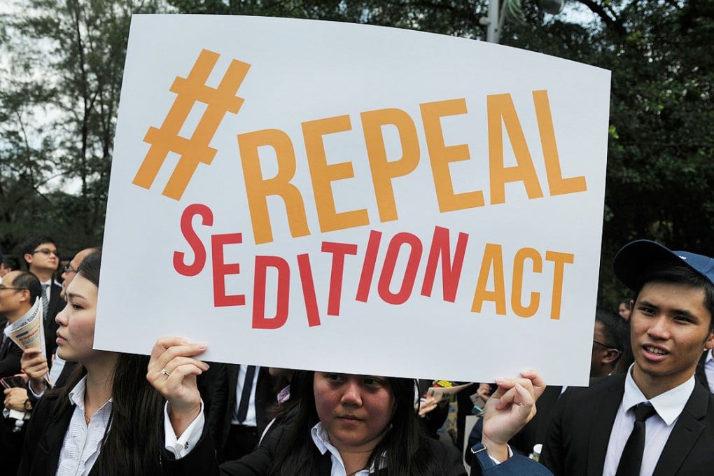 A Malaysian Lawyer holds a placard outside the Parliament in Kuala Lumpur during a rally to repeal the Sedition Act. Photo: AFP