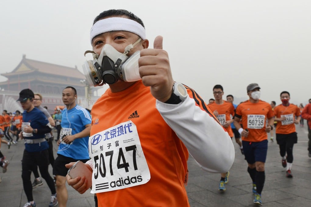 Runners leave Tiananmen Square during yesterday's Beijing marathon - despite the government warning the air quality was unsuitable for outdoor activities. Photo: Reuters