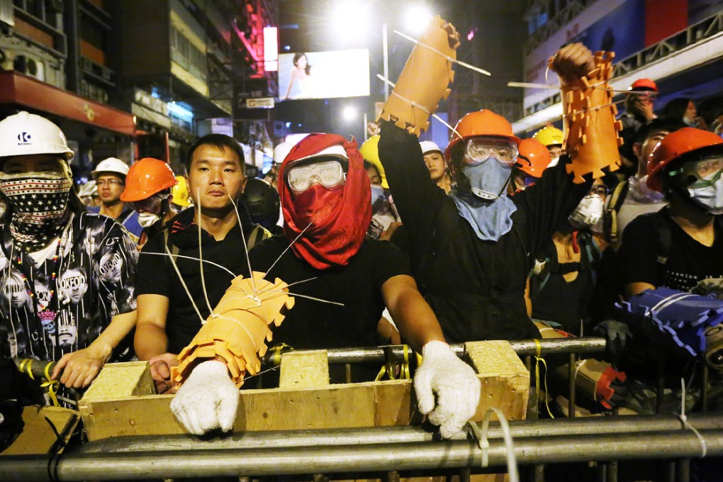 Protesters man the barricades in Mong Kok early yesterday. There have been violent clashes in the area since police reclaimed part of the rally site on Friday. Photo: Sam Tsang
