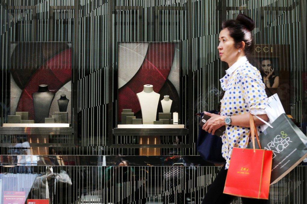 A woman walks past a closed shop when streets were occupied in Tsim Sha Tsui. Photo: David Wong