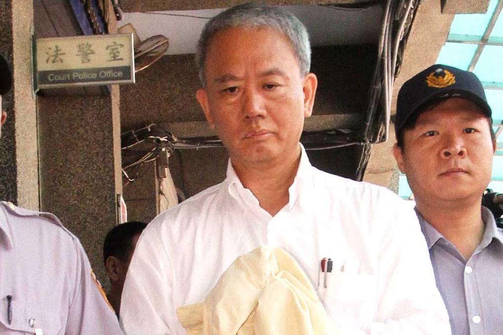 Wei Ying-chun is escorted by police at the Changhua district court in central Taiwan. Photo: AFP