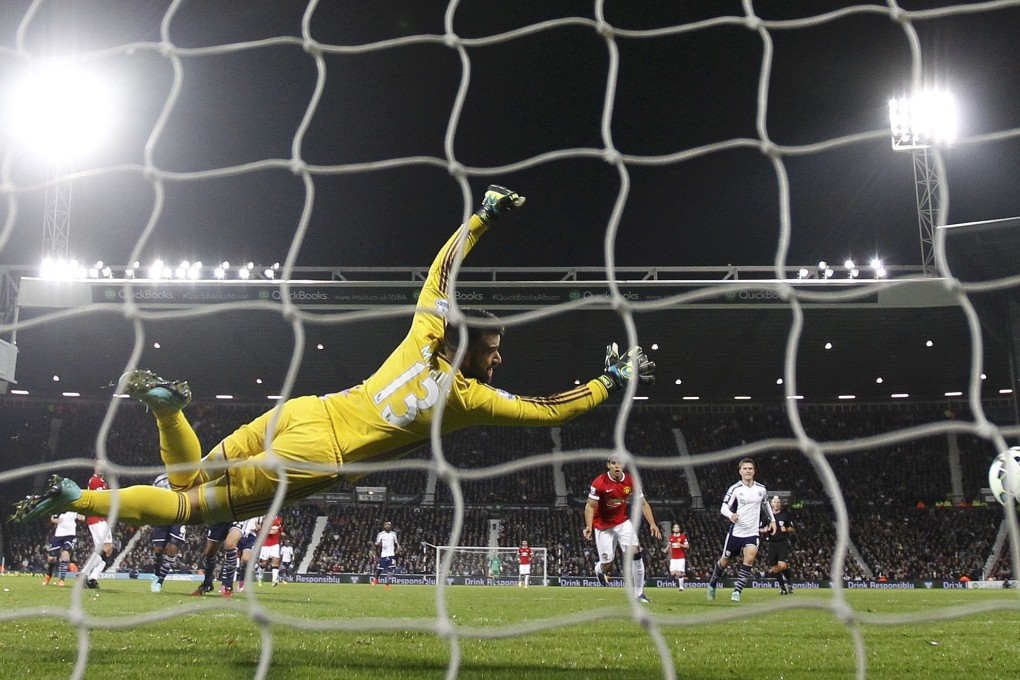 Daley Blind  fires past West Brom keeper Boaz Myhill to rescue a point for the Red Devils. Photo: Reuters