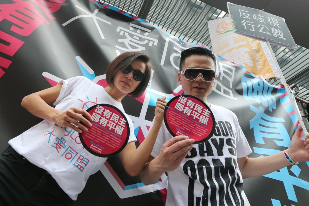 Canto-pop singers Denise Ho Wan-sze (left) and Anthony Wong Yiu-ming join a march in the streets to demand universal suffrage in Hong Kong. Photo: David Wong